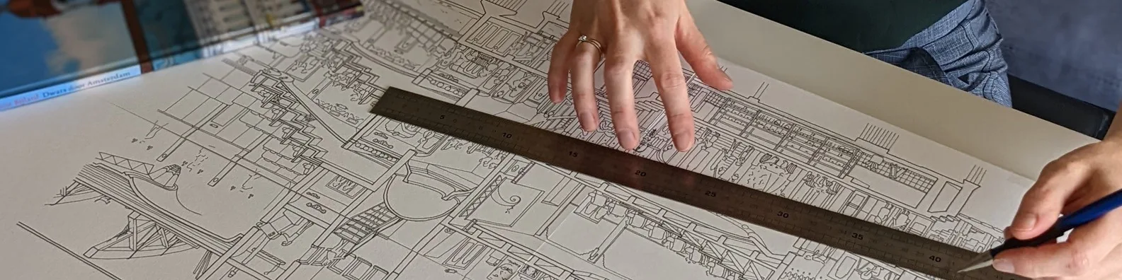 Handen met een liniaal en potlood op een grote doorsnede in fineliner